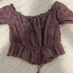 Purple cropped shirt.